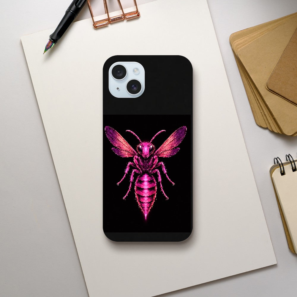Phone case with pink bee design on a black background, placed on a white surface with stationery items.