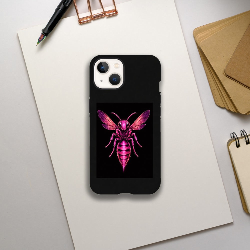 Black phone case with a pink and purple insect design on a white surface with stationery items.