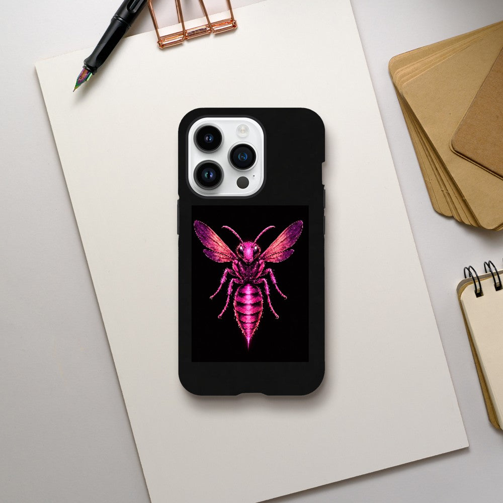 Phone case with a pink and purple insect design on a white surface with office supplies.