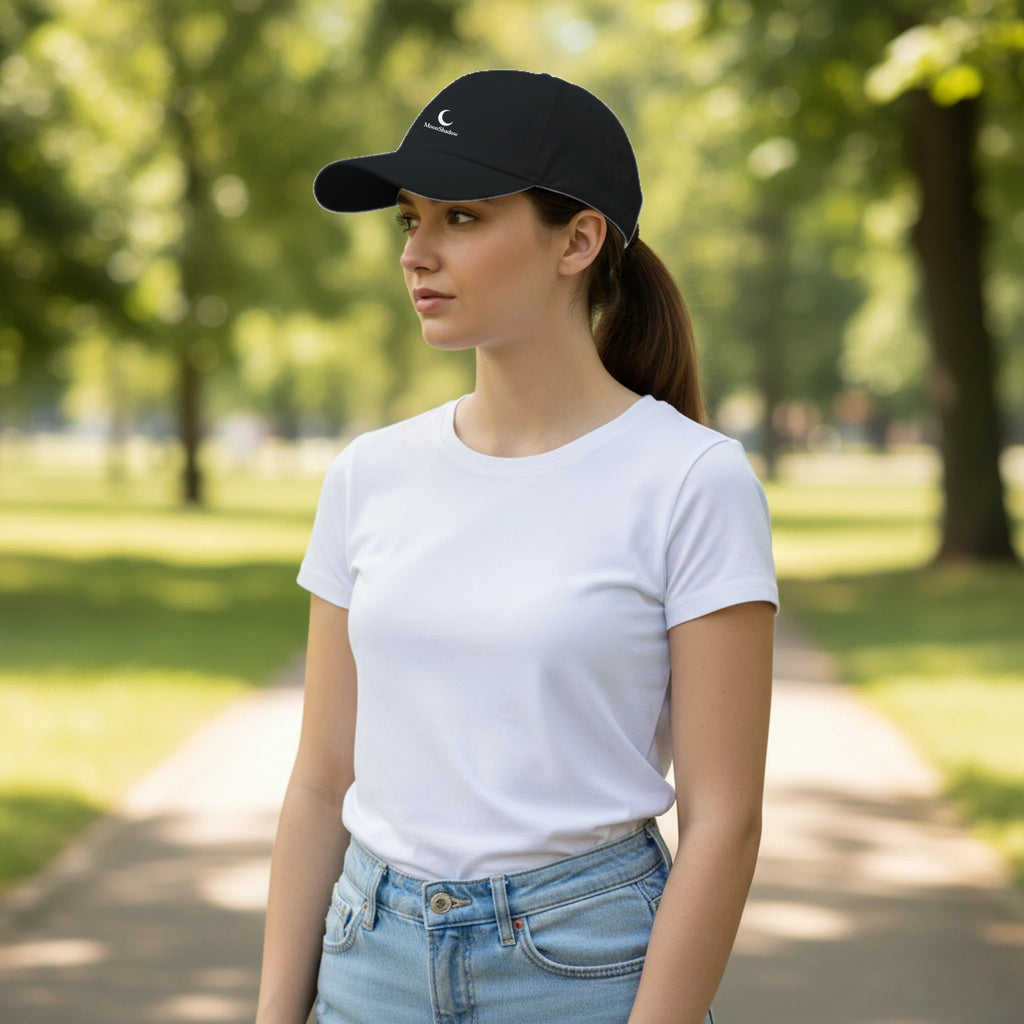 Woman wearing a black cap and white t-shirt in a park