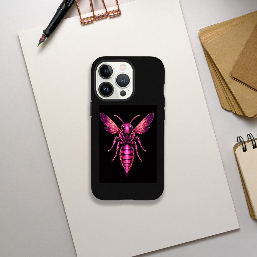 Phone case with pink bee design on a desk with stationery items