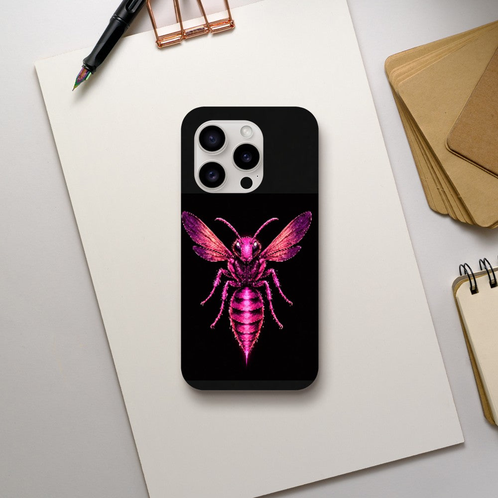 Phone case with pink bee design on a black background, placed on a white surface with stationery items.