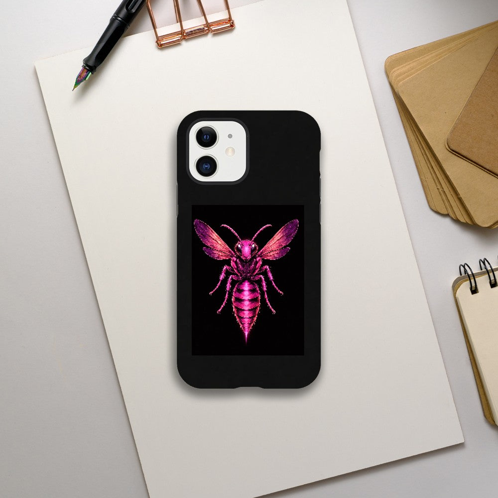 Phone case with a pink and purple insect design on a black background, placed on a white surface with stationery items.