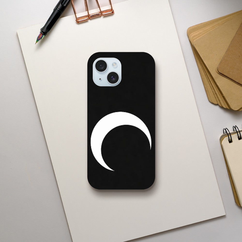 Black phone case with a white crescent moon design on a light gray surface.