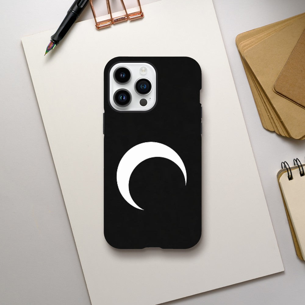Black phone case with a white crescent moon design on a light gray surface.