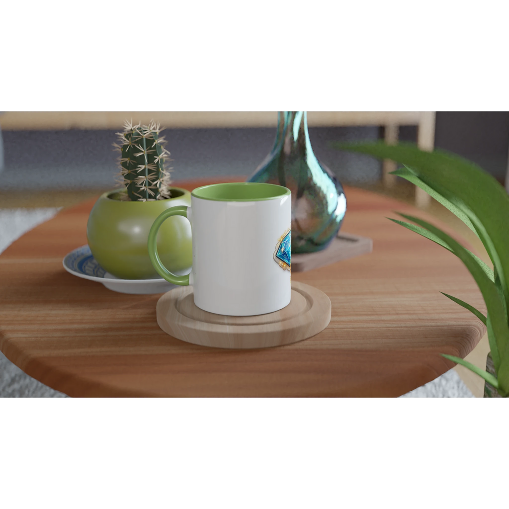 White mug with green handle on a wooden table with decorative items