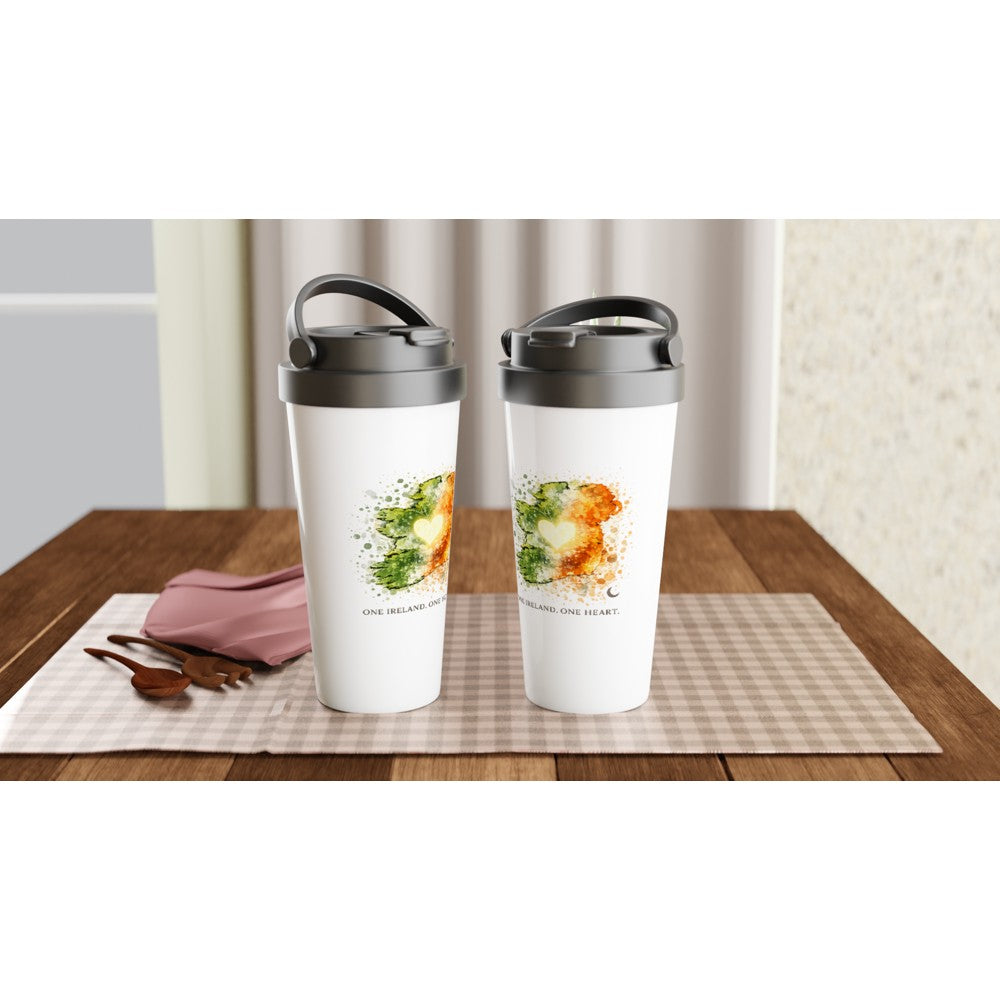 Ireland travel mug Two white tumblers with black lids on a wooden table with a checkered cloth.