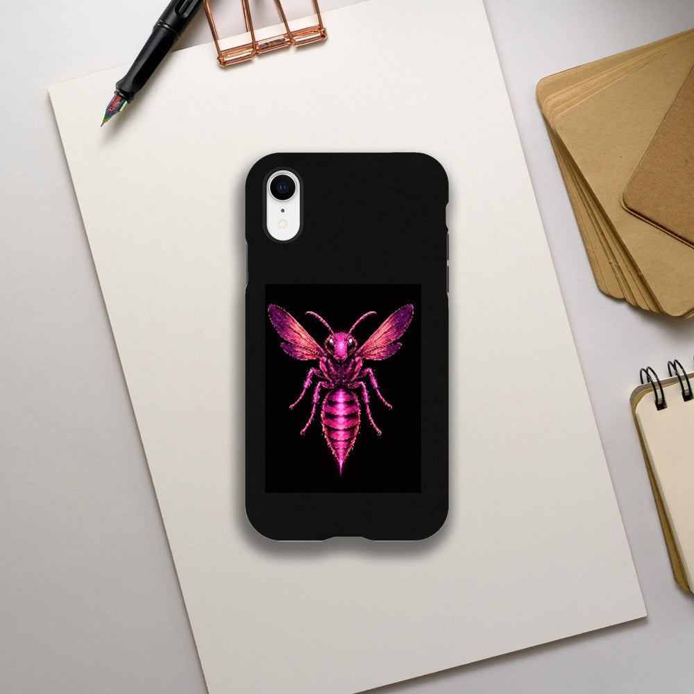 Phone case with pink bee design on a white surface with stationery items.